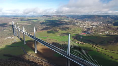 Millau-Viaduct-with-the-city-in-background-aerial-drone-shot-day-time-gorge